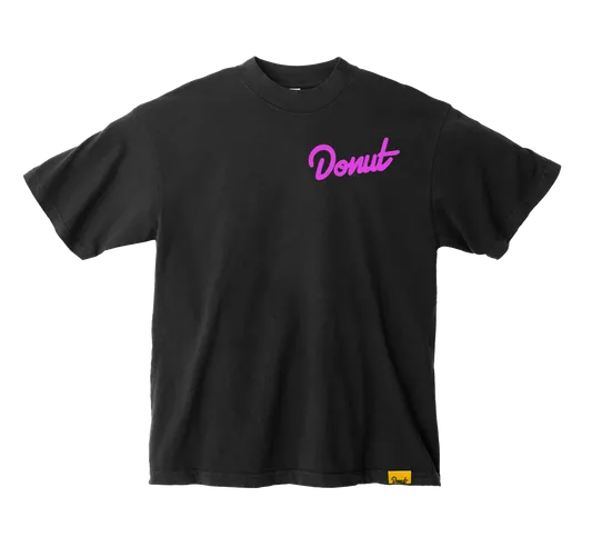 Black Donut Media t-shirt with a pink chest logo and branded yellow hem tag