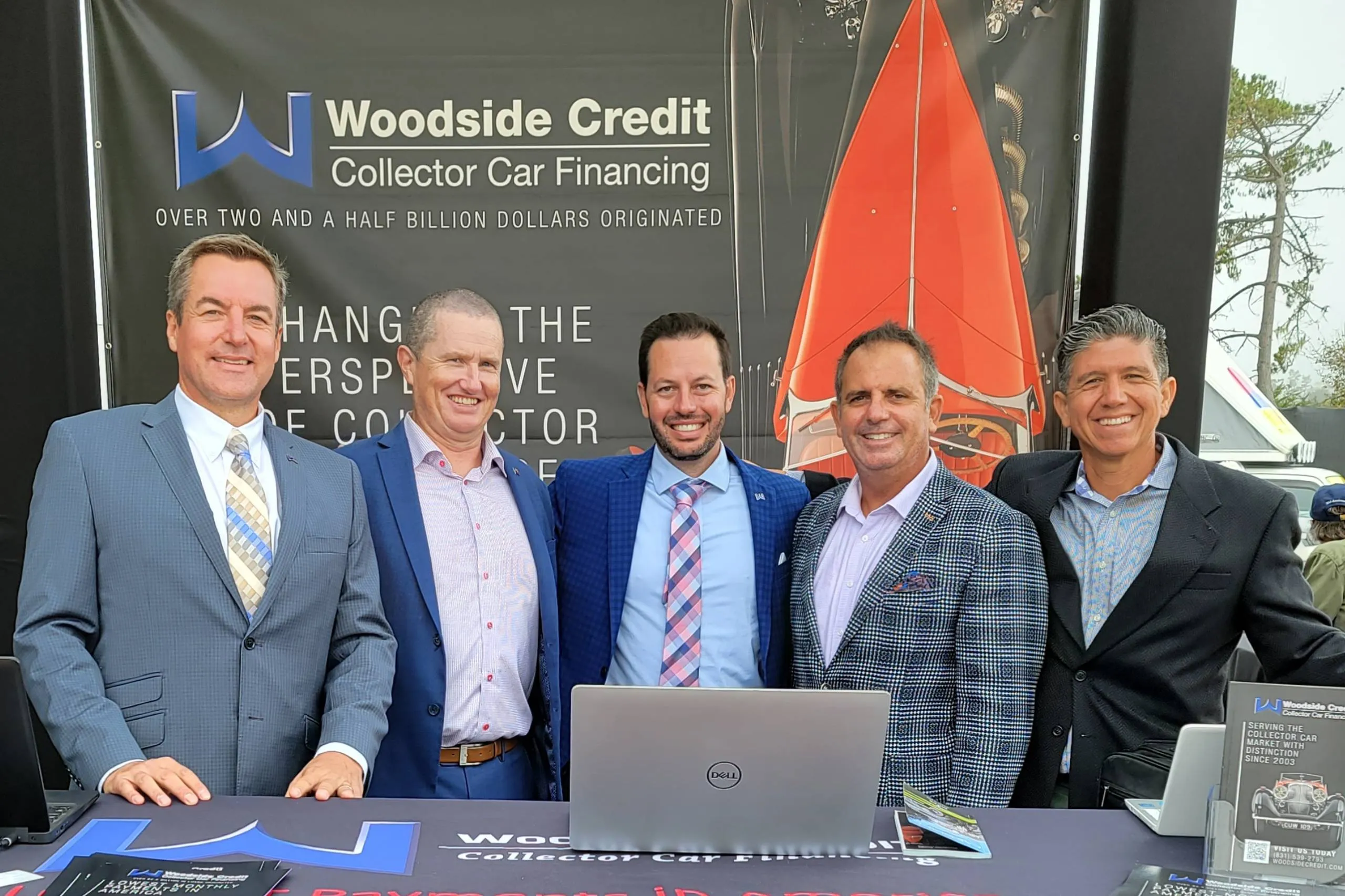 Woodside Credit team at a collector car event promotional booth